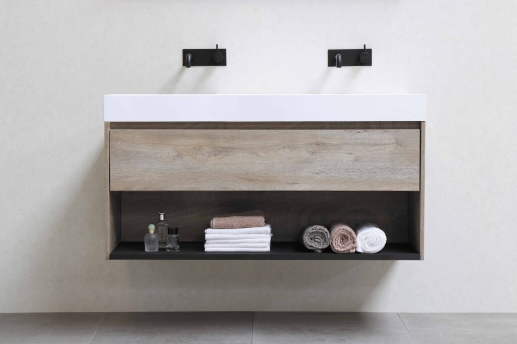 Wall-mounted double sinks and cabinets with an open shelf.